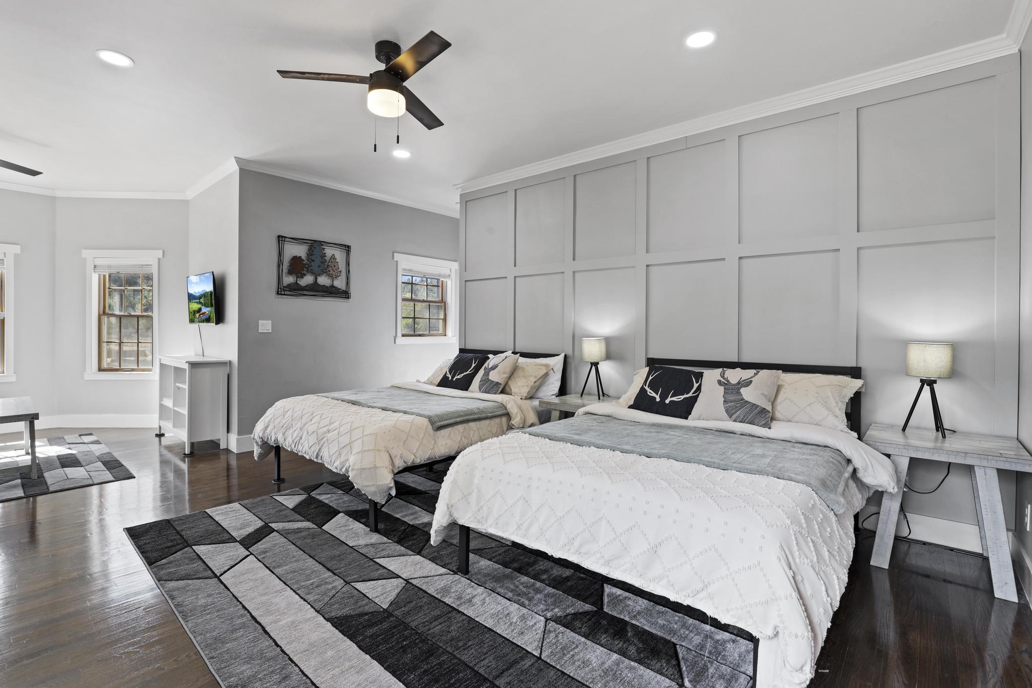 Bedroom with two queen beds and paneled wall detail